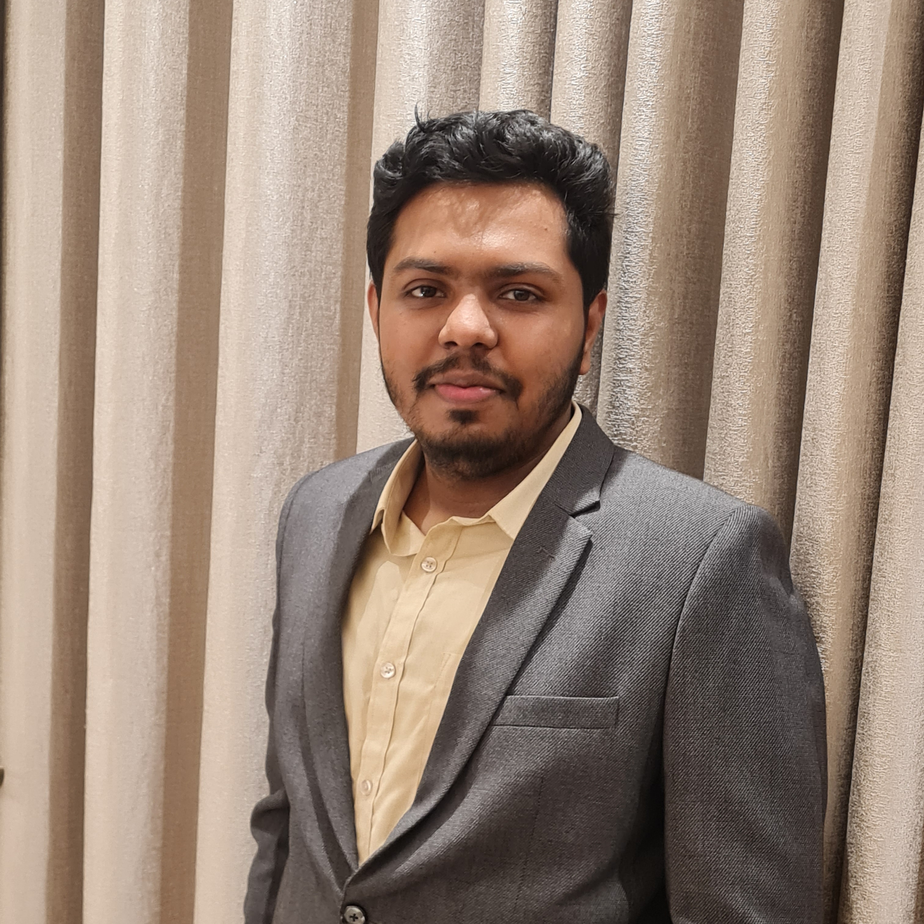A professional headshot of a confident Bangladeshi entrepreneur in business casual attire. He is smiling warmly against a soft-focus office background, radiating leadership and vision. The lighting is professional and clean, capturing a sense of reliable and approachable authority. - Punosristi Bangladesh Plastic Recycling